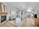 Open-concept living room featuring a stone fireplace and seamless transition to dining area at 3838 Brush Rd, Castle Rock, CO 80108