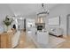 Open-concept living area with modern furniture and stone fireplace; view of entry at 3838 Brush Rd, Castle Rock, CO 80108