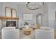 Bright living room with fireplace, neutral decor, and view to dining area at 3838 Brush Rd, Castle Rock, CO 80108