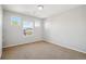 Bright bedroom features three windows offering natural light and neutral-toned walls at 13075 Tamarac St, Thornton, CO 80602