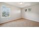 Bedroom boasts three windows offering natural light and light gray walls at 13075 Tamarac St, Thornton, CO 80602