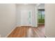 Bright entryway with hardwood floors, a double front door, and a view into an adjoining living area at 13075 Tamarac St, Thornton, CO 80602