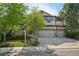Attractive two-story home with stone accents, a two-car garage, and a green lawn in a quiet neighborhood at 13075 Tamarac St, Thornton, CO 80602