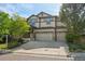 Well-maintained two-story home with stone accents, a two-car garage, and a green lawn in a suburban setting at 13075 Tamarac St, Thornton, CO 80602