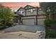 Beautiful two-story home with a two-car garage, stone accents, manicured lawn, and vibrant sunset backdrop at 13075 Tamarac St, Thornton, CO 80602