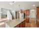 Open kitchen with stainless steel appliances, granite countertops, and view of the staircase at 13075 Tamarac St, Thornton, CO 80602