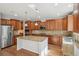 Spacious kitchen with granite countertops, stainless steel appliances, and a center island at 13075 Tamarac St, Thornton, CO 80602