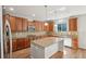 Modern kitchen with granite countertops, stainless steel appliances, and a center island at 13075 Tamarac St, Thornton, CO 80602