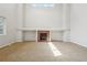 Spacious living room featuring a fireplace with a tile surround, carpet flooring, and ample natural light at 13075 Tamarac St, Thornton, CO 80602