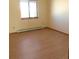 Bedroom with modern flooring, a window providing natural light, and neutral colored walls at 473 N Banner St # C, Elizabeth, CO 80107