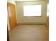 Bedroom featuring a large window, wood laminate flooring, and a double door closet at 473 N Banner St # C, Elizabeth, CO 80107