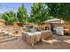 Outdoor living space with patio, fireplace, grill, and hot tub at 852 Pontiac St, Denver, CO 80220