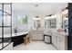Elegant bathroom with black freestanding tub, marble floors, and stylish vanities at 852 Pontiac St, Denver, CO 80220