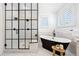Bright bathroom featuring a modern shower with black trim and a freestanding tub at 852 Pontiac St, Denver, CO 80220