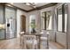 Bright breakfast nook featuring a round table, four chairs, and a large window at 852 Pontiac St, Denver, CO 80220