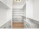 Walk-in closet features custom white shelving, drawers, and wood floor at 852 Pontiac St, Denver, CO 80220
