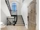 Bright entryway with staircase, large window, and wooden door with charming details at 852 Pontiac St, Denver, CO 80220