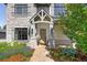 Inviting front entrance featuring a custom wood door, stone accents, and meticulously landscaped surroundings at 852 Pontiac St, Denver, CO 80220