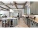 Bright kitchen with gray cabinetry, stainless steel appliances, and butcher block island at 852 Pontiac St, Denver, CO 80220