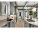 Bright kitchen with custom cabinets, stainless steel appliances, a center island, and hardwood floors at 852 Pontiac St, Denver, CO 80220