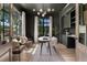 Stylish living room featuring dark walls, large windows, elegant lighting, and comfortable seating at 852 Pontiac St, Denver, CO 80220