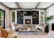 Cozy living room featuring a stone fireplace, built-in cabinets, comfortable seating, and elegant decor at 852 Pontiac St, Denver, CO 80220