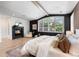 Spacious main bedroom with dark wallpaper, fireplace, white trim, and large windows at 852 Pontiac St, Denver, CO 80220
