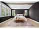 Serene main bedroom featuring dark wallpaper, neutral decor, large windows, and hardwood floors at 852 Pontiac St, Denver, CO 80220