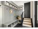 Mud room featuring built-in bench, storage shelves, and black herringbone floor at 852 Pontiac St, Denver, CO 80220