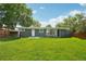 Backyard showing the lush lawn, patio, and green exterior of this charming home at 6155 Carr St, Arvada, CO 80004