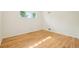 This room features a window, light-colored hardwood floors, and white walls at 6155 Carr St, Arvada, CO 80004