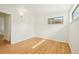 This room features wood floors, a window, and white walls at 6155 Carr St, Arvada, CO 80004