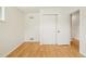 This bedroom features wood floors, closet space, and an open door into the hallway at 6155 Carr St, Arvada, CO 80004