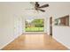 Bright dining room with a large window overlooking the backyard and a modern ceiling fan at 6155 Carr St, Arvada, CO 80004