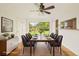 Staged dining room featuring a modern table, seating for eight, and a large window at 6155 Carr St, Arvada, CO 80004