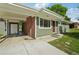 View of home showcasing a carport with a brick accent wall and a green horizontal siding at 6155 Carr St, Arvada, CO 80004