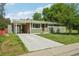 Charming home with a well-maintained lawn, a brick chimney, and a long driveway at 6155 Carr St, Arvada, CO 80004