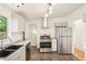 Modern kitchen featuring white cabinets, stainless steel appliances, and a subway tile backsplash at 6155 Carr St, Arvada, CO 80004