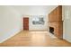 Bright living room featuring a brick fireplace, hardwood floors, and natural light at 6155 Carr St, Arvada, CO 80004