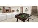 Modern living room with a foosball table and fireplace at 6155 Carr St, Arvada, CO 80004