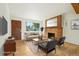 Bright, staged living room featuring a brick fireplace, neutral tones, and modern furniture at 6155 Carr St, Arvada, CO 80004
