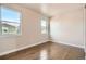 Simple bedroom with wood floors and two windows at 6861 Clay St, Denver, CO 80221