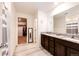 Double vanity bathroom with granite countertops and walk-in shower at 47387 Lilac Ave, Bennett, CO 80102