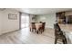 Bright dining room featuring a table with six chairs and access to kitchen at 47387 Lilac Ave, Bennett, CO 80102