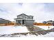 Two-story house with gray siding, attached garage, and covered porch at 47387 Lilac Ave, Bennett, CO 80102