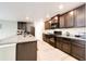 Modern kitchen with granite countertops and dark wood cabinets at 47387 Lilac Ave, Bennett, CO 80102