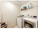 Laundry room with washer, dryer, and shelving at 47387 Lilac Ave, Bennett, CO 80102