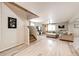 Spacious living room with L-shaped sofa, large TV, and hardwood floors at 47387 Lilac Ave, Bennett, CO 80102