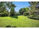 Serene backyard featuring lush greenery, mature trees, and a well-manicured lawn, offering a private outdoor space at 1010 Home Farm Cir, Denver, CO 80234
