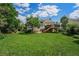 The house features a wooden deck overlooking a large manicured lawn at 1010 Home Farm Cir, Denver, CO 80234